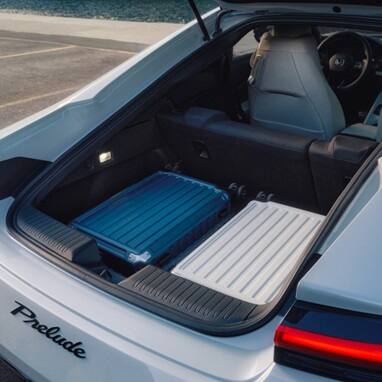 2027 Honda Prelude cargo area with 2 suitcases in it (exhilarating hybrid coupe).