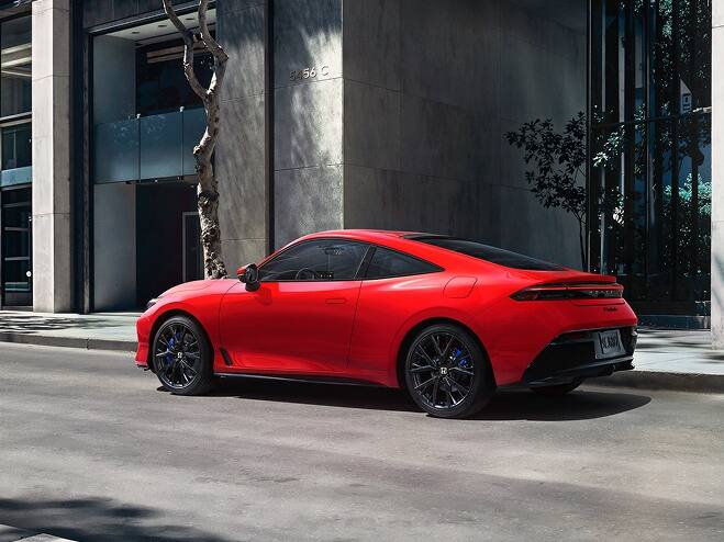 2027 Honda Prelude in Rallye Red, 3/4 rear view, parked alone the street in the down town (exhilarating hybrid coupe).
